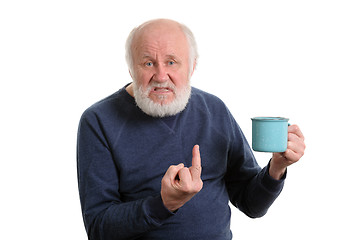 Image showing senior man with cup shows middle finger isolated on white