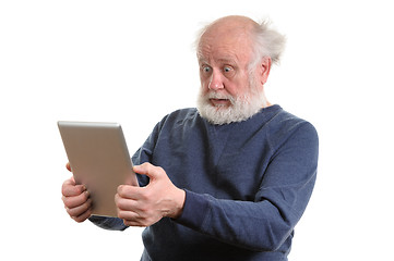 Image showing Funny shocked senior man using tablet computer isolated on white