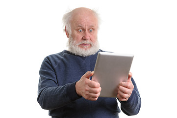 Image showing Funny shocked senior man using tablet computer isolated on white