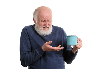 Image showing unhappy elderly man with cup of bad tea or coffee isolated on white