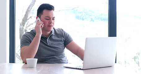 Image showing businessman working using a laptop in startup office