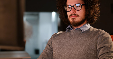 Image showing man working on computer in dark office