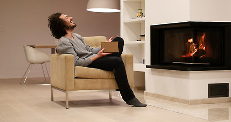 Image showing young man at home reading book