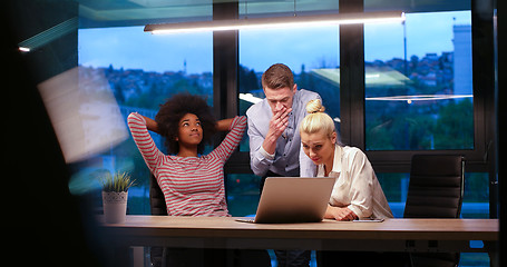 Image showing Multiethnic startup business team in night office