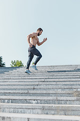 Image showing Fit man doing exercises outdoors at city