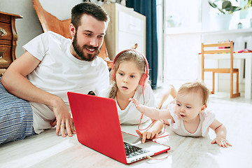 Image showing father and his daughters at home