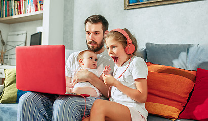 Image showing father and his daughters at home