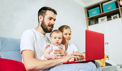 Image showing father and his daughters at home