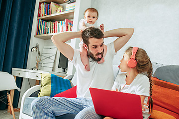 Image showing father and his daughters at home