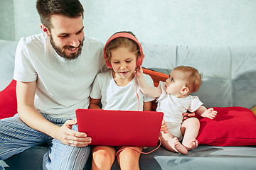 Image showing father and his daughters at home