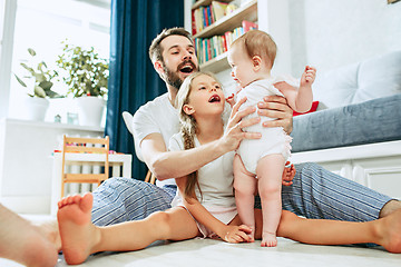 Image showing Proud father holding his newborn baby daughter at home