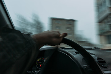 Image showing Riding behind the wheel of a car in winter