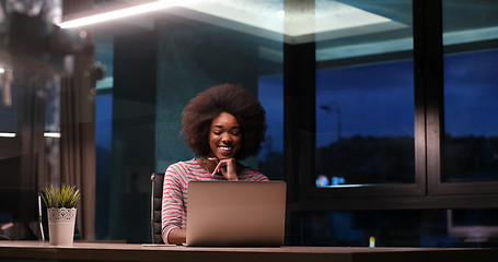 Image showing black businesswoman using a laptop in night startup office