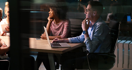 Image showing Multiethnic startup business team in night office