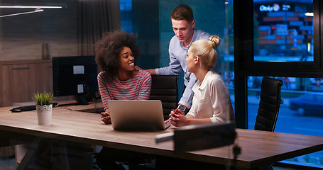 Image showing Multiethnic startup business team in night office