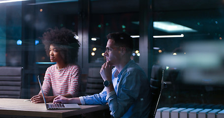 Image showing Multiethnic startup business team in night office