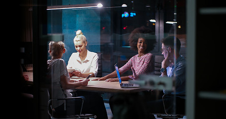 Image showing Multiethnic startup business team in night office