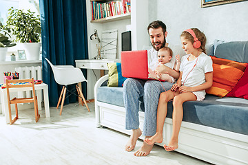 Image showing father and his daughters at home