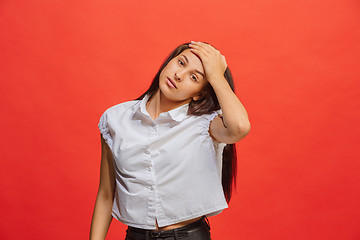 Image showing Woman having headache. Isolated over red background.
