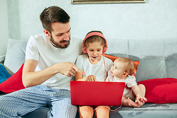 Image showing father and his daughters at home