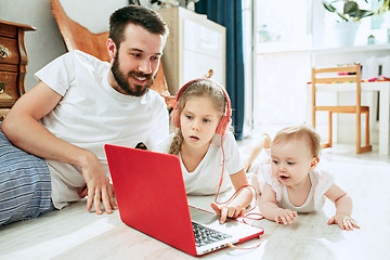 Image showing father and his daughters at home