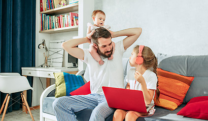 Image showing father and his daughters at home