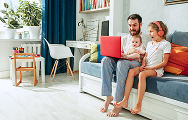 Image showing father and his daughters at home