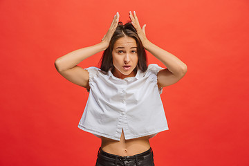 Image showing Woman having headache. Isolated over red background.