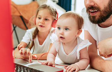 Image showing father and his daughters at home