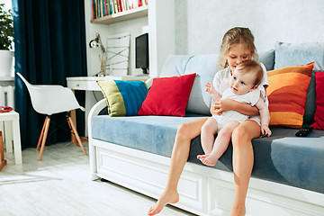 Image showing adorable two sisters on bedroom