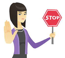 Image showing Asian business woman holding stop road sign.