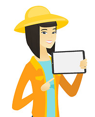 Image showing Young asian farmer holding tablet computer.