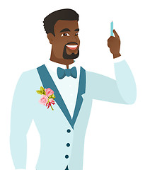 Image showing Young african-american smiling groom with pen.