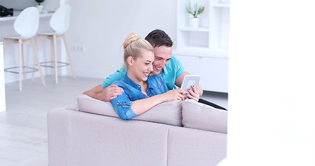 Image showing couple relaxing at  home with tablet computers