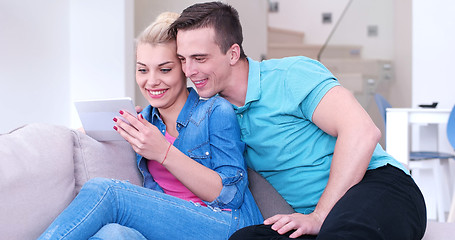 Image showing couple relaxing at  home with tablet computers