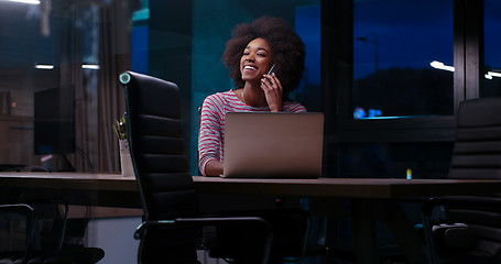 Image showing black businesswoman using a laptop in night startup office