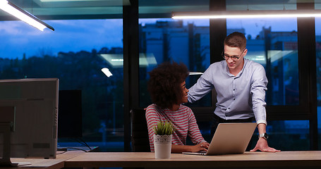 Image showing Multiethnic startup business team in night office