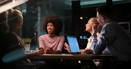 Image showing Multiethnic startup business team in night office