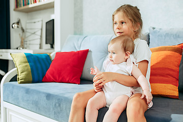 Image showing adorable two sisters on bedroom