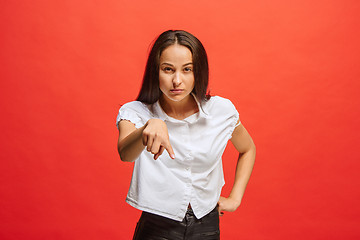 Image showing The overbearing business woman point you and want you, half length closeup portrait on red background.