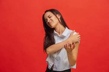 Image showing Young woman overwhelmed with a pain in the shoulder