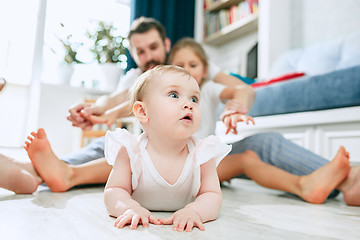 Image showing Proud father holding his newborn baby daughter at home