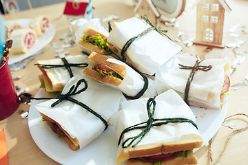 Image showing Girl birthday decorations. table setting from above with cakes, drinks and party gadgets.