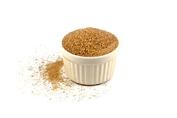 Image showing Brown cane sugar in ceramic bowl isolated on white background.