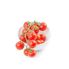 Image showing Fresh organic wet cherry tomatoes bunch on ceramic bowl.