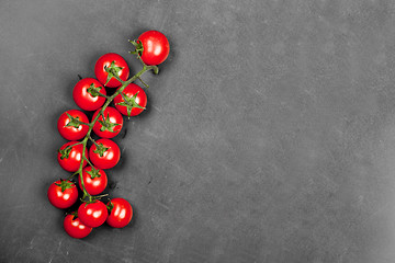 Image showing Top view of fresh organic cherry tomatoes bunch on black board