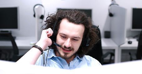 Image showing male call centre operator doing his job