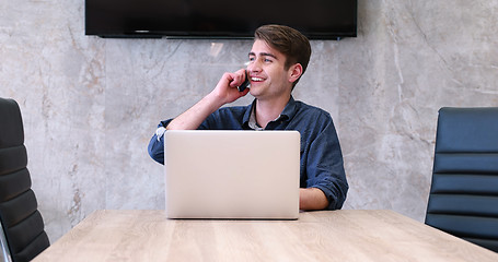 Image showing businessman working using a laptop in startup office