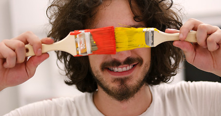 Image showing man with funny hair over color background with brush