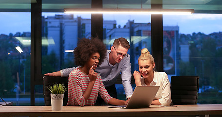 Image showing Multiethnic startup business team in night office